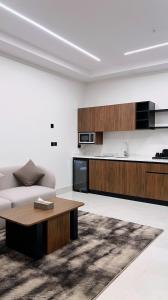 a living room with a couch and a table at البرج للشقق المخدومة 2 in Al Nairyah
