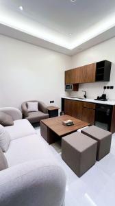 a living room with a couch and a table at البرج للشقق المخدومة 2 in Al Nairyah +15 photos