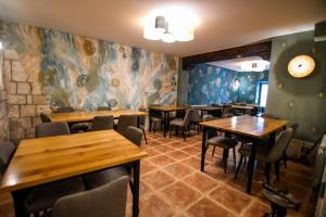 a dining room with wooden tables and chairs at La Cachava in Castrojeriz