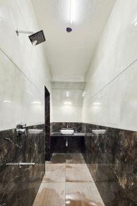 a large bathroom with a sink and a tub at The Urban Escape in Udupi