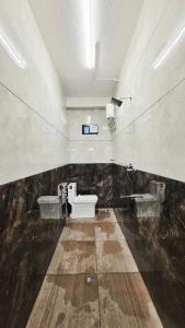 a bathroom with a toilet and a sink at The Urban Escape in Udupi