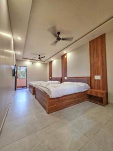 a bedroom with a large bed with a ceiling at The Urban Escape in Udupi