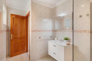 a bathroom with a sink and a glass shower at El Gin in Playa Blanca +12 photos