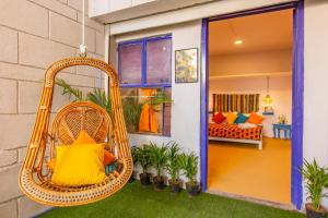a porch with a swing in a house at goSTOPS Lite Jaipur in Jaipur