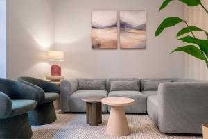 a living room with a couch and two chairs and a table at Casa 1872, by Homing U in Seville +54 photos