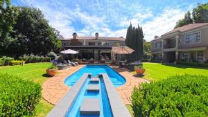 a swimming pool in the backyard of a house at 58 On Hume in Johannesburg