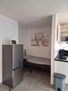 a small room with a refrigerator and a kitchen at Linda's Appartement in Bochum