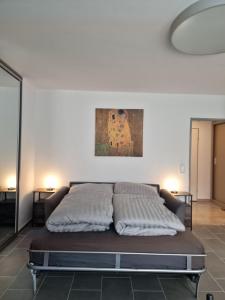 a bed in a bedroom with a painting on the wall at Linda's Appartement in Bochum