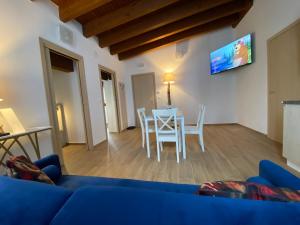 a living room with a blue couch and a table at International Residence in Tarvisio