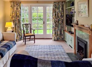 a living room with a fireplace and a window at 2 Bed in Chilmark oc-w32753 in Chilmark
