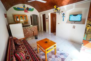 a living room with a table and a refrigerator at Osman House Luxor in Luxor