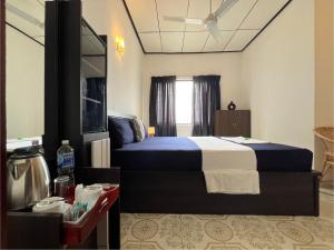 a hotel room with a bed and a tv at RIVINSON Negombo in Negombo +52 photos