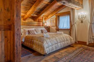 Postel nebo postele na pokoji v ubytování CHALET LUMIERE - Scopri il Lusso