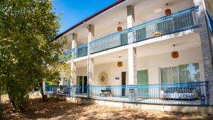 an exterior view of a building with blue balconies at Albatlos in Yaka