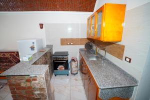 a kitchen with a sink and a stove at Osman House Luxor in Luxor
