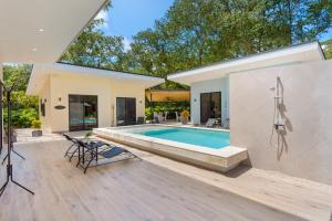 a swimming pool in the backyard of a house at Le MaGil Boutique Hotel in Tamarindo