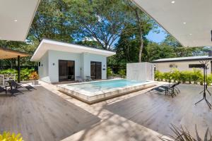 a backyard with a pool and a house at Le MaGil Boutique Hotel in Tamarindo +18 photos