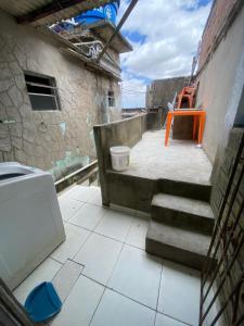 an outdoor area with stairs and a orange chair at Alugo casa festival de inverno in Garanhuns