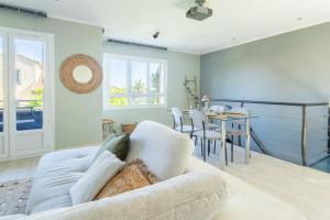 a living room with a couch and a table at Le Duplex de Bandol - Au centre in Bandol +15 photos
