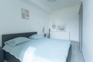a bed with white sheets and pillows in a bedroom at Le Cocon d'Allauch - T3 avec jardin in Allauch
