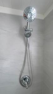 a shower head on the wall of a bathroom at Tickled Pink in Harbour Island +16 photos