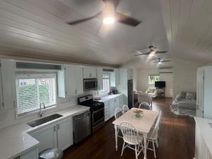 a kitchen and living room with a table and chairs at Tickled Pink in Harbour Island