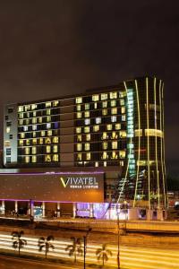 a large building with a vaughani sign in front of it at night at Vivatel Kuala Lumpur in Kuala Lumpur