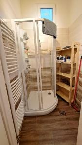 a shower with a glass door in a bathroom at Gaia Astoria in Budapest +46 photos