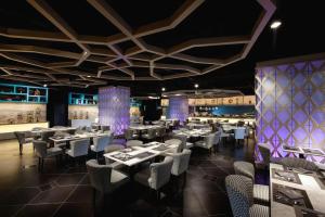 a restaurant with tables and chairs in a room at Vivatel Kuala Lumpur in Kuala Lumpur