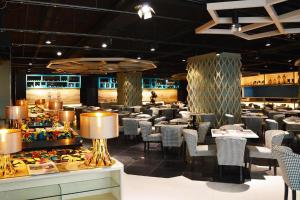 a restaurant with chairs and tables in a room at Vivatel Kuala Lumpur in Kuala Lumpur