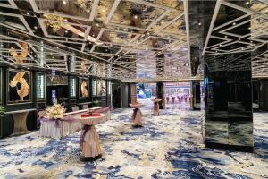 a lobby with a blue and white patterned floor at Vivatel Kuala Lumpur in Kuala Lumpur