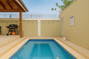 a swimming pool in the backyard of a house at Sky Blue in Jarabacoa