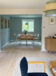 a dining room with a table and chairs at Classic Swedish Wooden House Near Sea And Forest in Svängsta +21 photos