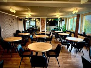 a restaurant with tables and chairs in a room at Jugendgästehaus Laubach in Laubach
