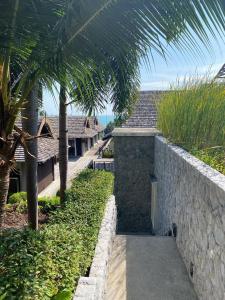 a pathway leading to a resort with palm trees at Sea top room in Amphoe Koh Samui