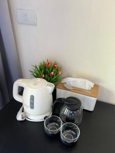 a counter top with a coffee maker and some bowls at Sea top room in Amphoe Koh Samui
