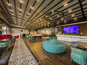 a large room with a large tv and a table at Leaf Port Hotel in Antalya +51 photos