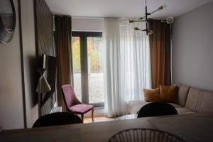 a living room with a couch and a window at Apartment Nuve in Bjelašnica
