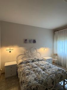a bedroom with a bed and two tables and a window at A casa di Rita in Toro