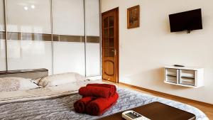 a bedroom with a bed with red towels on it at Олександрійський б-р 125 CityRooms in Bila Tserkva +21 photos