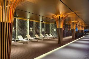 a row of white chairs in a building with columns at Vivatel Kuala Lumpur in Kuala Lumpur