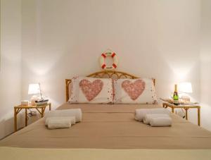 a large bed with two pillows with hearts on it at Costal Vibe in Isola della Malva