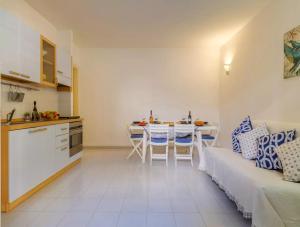 a kitchen and living room with a couch and a table at Costal Vibe in Isola della Malva +15 photos