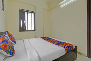 Postel nebo postele na pokoji v ubytování FabHotel Paradise Inn Moshi + 17 fotografií