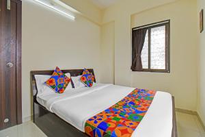 Postel nebo postele na pokoji v ubytování FabHotel Paradise Inn Moshi