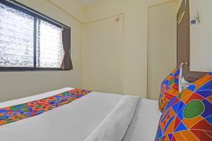 Postel nebo postele na pokoji v ubytování FabHotel Paradise Inn Moshi