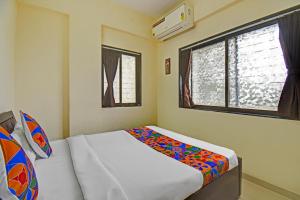 Postel nebo postele na pokoji v ubytování FabHotel Paradise Inn Moshi