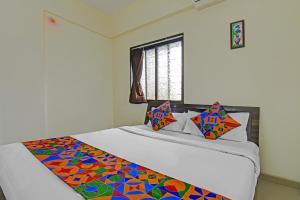 Postel nebo postele na pokoji v ubytování FabHotel Paradise Inn Moshi