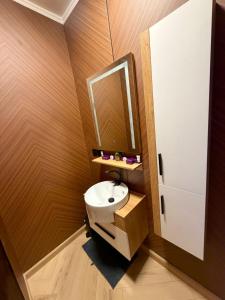 a small bathroom with a sink and a mirror at D3S 3BR Apartment in Makkah
