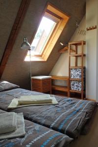 a bedroom with a bed and a large window at Ferienhaus Altes Elbschifferhaus in Königstein an der Elbe
